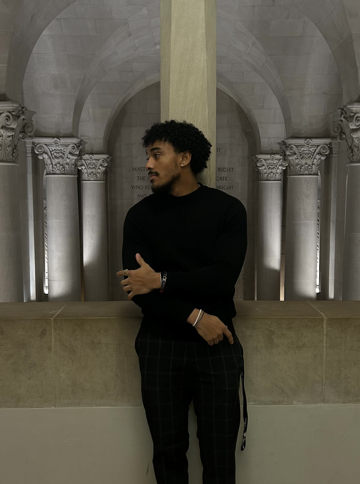 Image shows a male student in front of a marble background